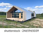 Barn House construction. Barnhouse in countryside. Modern Wooden house construction in rural. Build Scandi Barn home in rural. Barndominium construction. Timber Frame Barn. Wooden frame house