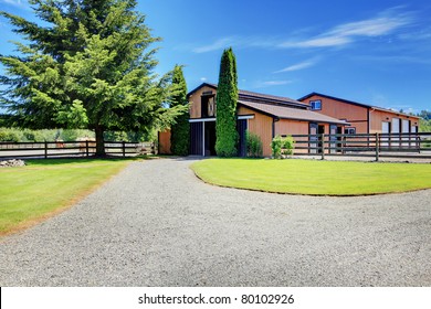 Barn And Pasture Ground At The Horse Ranch In Washington State, USA With The Wood Fence And The Houses In The Background.