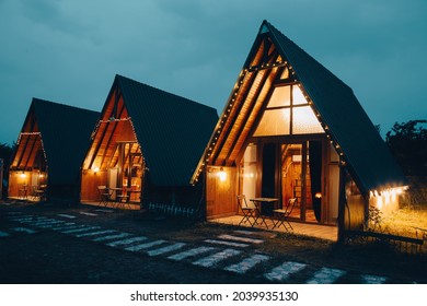 Barn styled vintage looking wooden bungalow house. Twilight scene in dark horror concept.