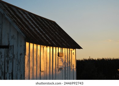Barn with sun setting upon it in Central IL.