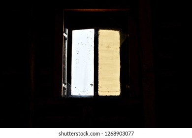 barn window in dark background