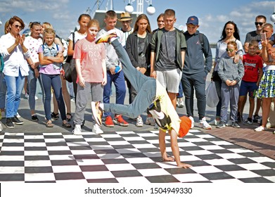 Barnaul, RUSSIA - 24 August 2019: A 9-12 Year Old Boy Dances A Break Dance During Dance Battles.