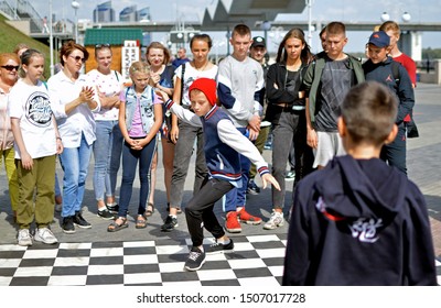 Barnaul, RUSSIA - 24 August 2019: A 9-12 Year Old Boy Dances A Break Dance During Dance Battles. The Confrontation Between The Dancers.