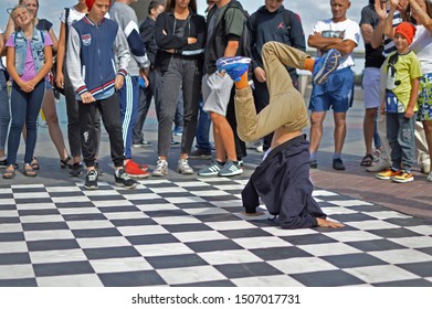 Barnaul, RUSSIA - 24 August 2019: A 9-12 Year Old Boy Dances A Break Dance During Dance Battles. The Confrontation Between The Dancers.