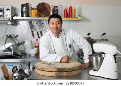 Barnaul. Russia. March 12, 2010 Portrait Of A Professional Chinese Chef In A White Uniform In A Professional Kitchen. Restaurant, Professional Concept.