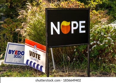 Barnegat Light, NJ - Oct. 15, 2020: Political Signs For The 2020 Presidential Election Are In A Yard With One Saying Your Vote Counts And Another Has NOPE With A Caricature Of Donald Trump For The O.