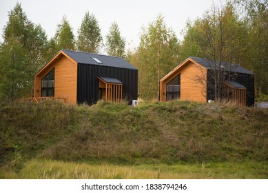 Barnhouse style house. House in the bosom of nature. Greenery and trees.