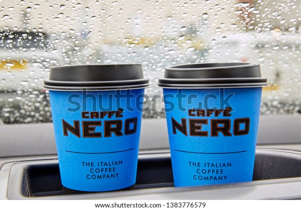 BARNSTAPLE, DEVON UK - APRIL\
24TH 2019- \'Caffe Nero\' disposable coffee cups on car dashboard\
during rain