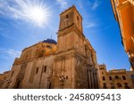 Baroque Basilica of Santa María in Elche, Alicante, Valencian Community, Spain, with the midday sun shining overhead