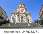 Baroque Duomo di San Giorgio or Cathedral of San Giorgio in Ragusa Ibla, Sicily, Italy, containing a flight of 250 steps, massive ornate columns, statues of saints and decorated portals