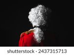 Baroque man from behind with white wig and red blazer