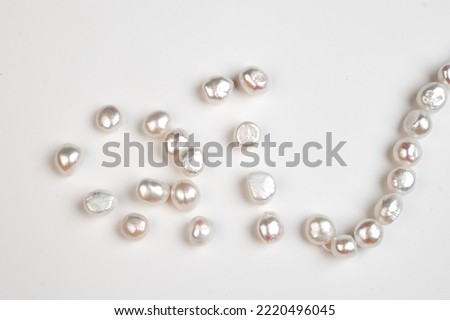 Baroque pearls strand. Natural freshwater pearl beads on white background. Top view. 