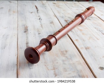 Baroque Recorder Or Flute Isolated On A Wooden Background, Music Instrument