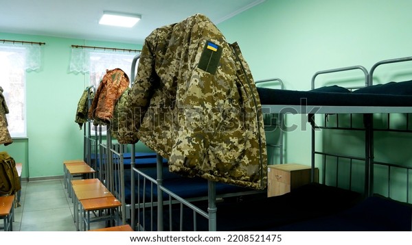 Barracks in the\
Ukrainian army. The Soldiers\' Room has bunk beds. Military uniforms\
hang on the beds. Ukraine is defending its territory from a Russian\
attack. Real War 2022 