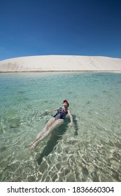 Barreirinhas, Maranhão / Brazil - 08/10/2017: Woman Floating In Water Of Lake - Lençóis Maranhenses National Park  