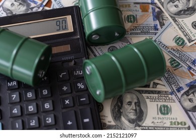 Barrel Of Crude Oil On Calculator With Dollar Bills. Close Up. Business Concept.