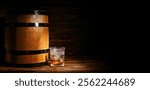 Barrel and glass of rum on dark wooden background with space for text