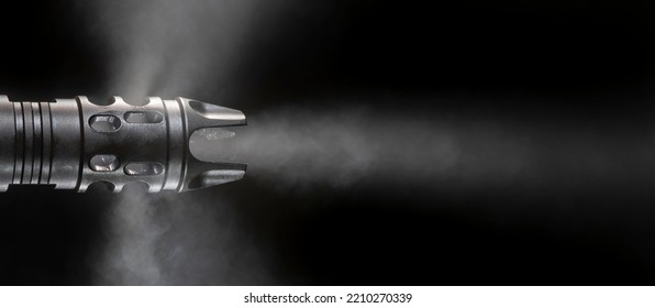 Barrel Of A Gun With Smoke Coming Out On A Black Background