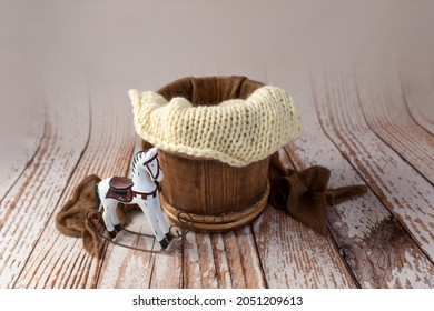 a barrel made of wood with a toy retro horse. basket for a photo shoot of newborns. furniture for dolls