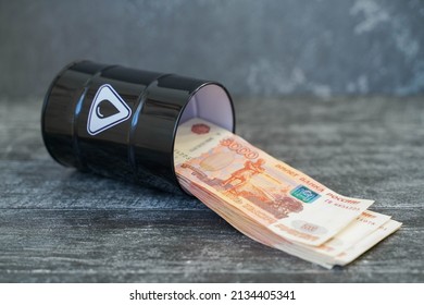 Barrel Of Oil And Banknotes Five Thousand Rubles On A Gray Background.