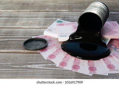 Barrel With Oil, Chinese Yuan Notes On A Wooden Background. Oil Production. Sale. Purchase. Raw Materials.