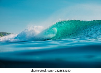 Barrel wave in ocean. Blue wave with sun light