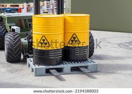 Barrels with poisonous substance. Poisonous chemicals in yellow barrels. Hazardous substances on forklift. Concept transporting poisonous cargo. Radiation hazard sign. Waste of chemical production