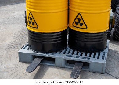 Barrels With Toxic Products. Barrels With Symbol Of Radiation Hazard. Plastic Pallet With Radioactive Liquid. Concept Toxic Industry. Toxic Waste In Yellow Barrels. Transportation Radioactive Liquid