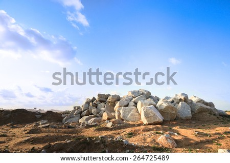 Barren landscape with hill of rock boulder stone