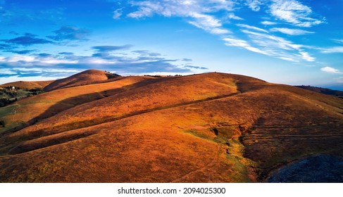 Barren landscape of Zlatibor mountain hill slopes in autumn sunset, aerial view from drone pov