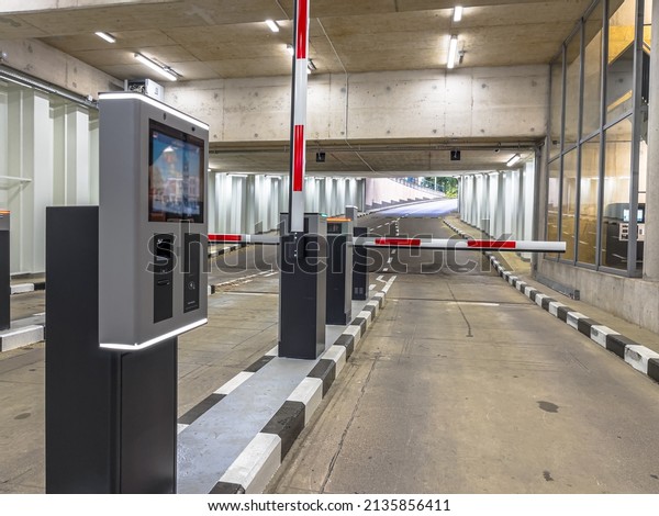 Barrier at Entrance and Exit of a car Parking\
garage. Fully automated barrier from car park. Underground parking,\
garage. Interior of\
parking