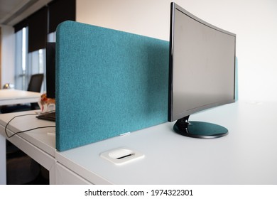 Barrier Placed Between Two Office Desks In Preparation Of People Coming To Work Into The Office. End Of The Covid Pandemic, People Stopping To Work From Home