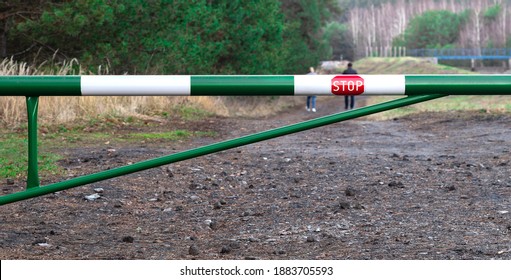 Barrier With Stop Sign And Two People Who Breaking Rules.