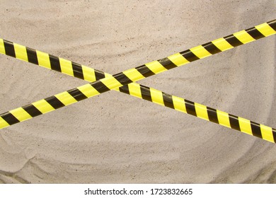 Barrier Tape - Quarantine, Isolation, Entry Ban. Close Up Sand Beautiful Smooth Texture On Beach In Summer Sun.