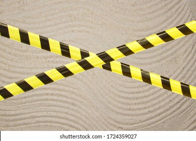 Barrier Tape - Quarantine, Isolation, Entry Ban. Close Up Sand Beautiful Smooth Texture On Beach In Summer Sun.