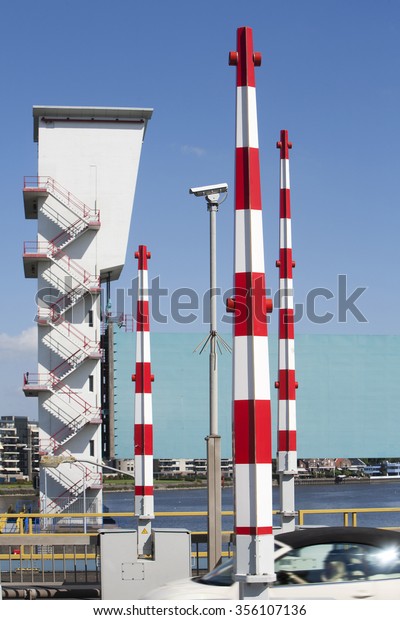 Barriers on the Algera bridge\
in Krimpen aan den IJssel. The storm surge barrier in the\
background was the first installation of the Delta Works in the\
Netherlands.