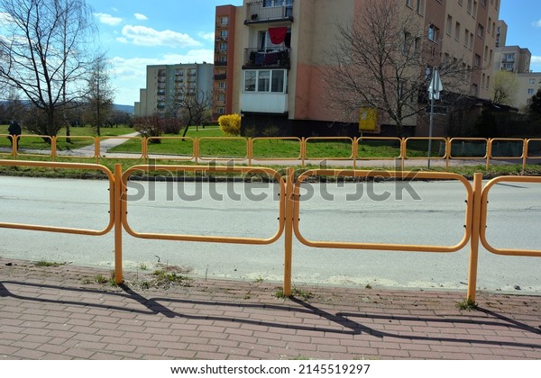 Barriers separating the road from the pavement in\
a housing estate near the\
school