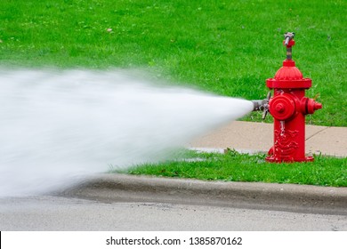 Barrington, IL/USA - 05-01-2019:  Closeup of fire hydrant being flushed by public works during spring maintenance