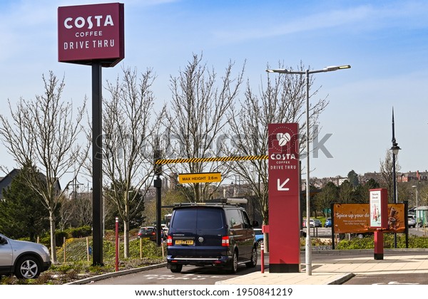 Barry, Wales -\
March 2021: Vehicle driving into the entrance of a drive thru pick\
up point at a branch of\
Costa.