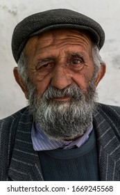 Bartang, Tajikistan - June 18, 2019: Portait Of An Old Man With Beard And Hat In The Bartang Valley In Tajikistan.