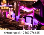 Bartender crafting a cocktail at the bar, perfect for vibrant bar scenes and drink menus