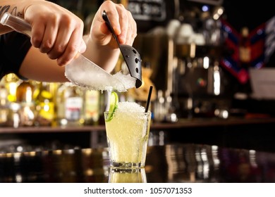 Bartender Is Decorating Cocktail With Crushed Ice At Bar Counter Background.