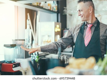 Bartender Doing Flair Inside American Bar - Barman At Work Performing Freestyle - Focus On Man Face - Bartending, Vacation, Tropical, Cocktails And Show Entertainment Concept - Retro Filter