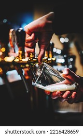 Bartender Hand At Beer Tap Pouring A Draught Beer In Glass Serving In A Bar Or Pub. Tap Room