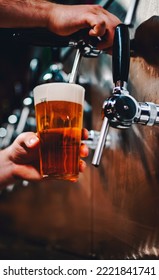 Bartender Hand At Beer Tap Pouring A Draught Beer In Glass Serving In A Bar Or Pub. Tap Room