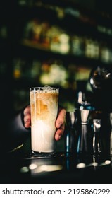 Bartender Hand Hold Coffee Creamy Cocktail In Glass In Bar