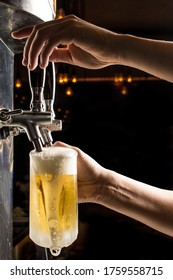 Bartender Hands Pouring A Cold Draft Beer Into A Mug , Black Background. Pilsen