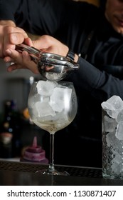 The Bartender Makes A Cocktail At The Bar. Macro Shooting With Drops And Hands