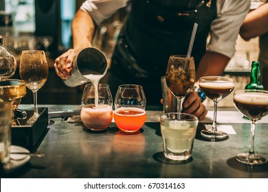Bartender making alcoholic cocktail, summer cocktail in bar