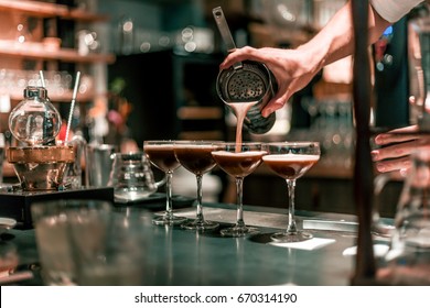 Bartender making alcoholic cocktail, summer cocktail in bar - Powered by Shutterstock